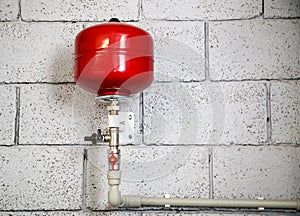 Closeup of manometer, pipes and faucet valves of heating system in a boiler room at home