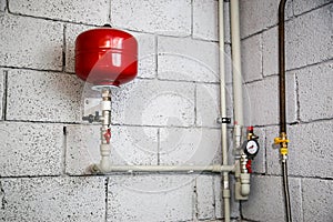 Closeup of manometer, pipes and faucet valves of heating system in a boiler room at home