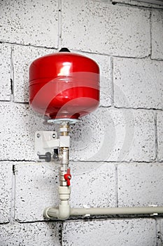 Closeup of manometer, pipes and faucet valves of heating system in a boiler room at home