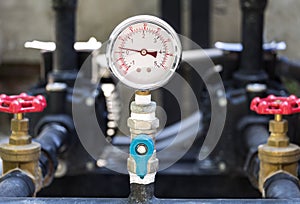 Closeup of manometer pressure gauge. Chrome pipes and valves w