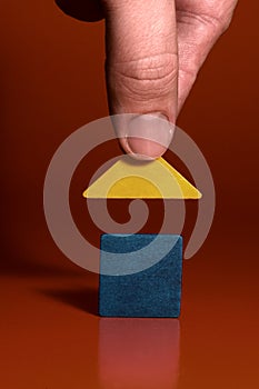 Closeup of a mans hand building a house