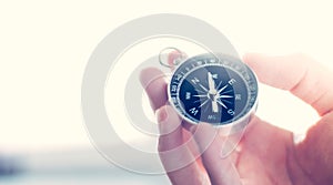 Innovation concept: Man is holding a compass in his hand, closeup cutout photo