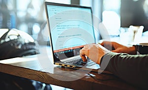 Closeup mans hands freelancer sitting in cafe working laptop