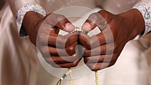 Closeup of mans hands while praying