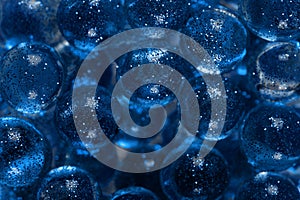 Closeup many transparent balls sprinkled with sparkles. Trendy banner with color of the year 2020 - Classic Blue