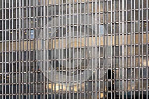 Closeup of many windows on old vintage skyscraper office building.
