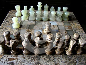 Closeup of a marble Chessboard. Chess is a two-player strategy board game played on a checkered board with 64 squares arranged in