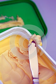 Closeup of a margarine container and knife