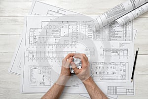 Closeup masculine hand with hand-folding a piece of paper.