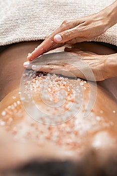 Woman applying rock salt on back