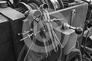 Closeup of a measuring special equipment like calipers, dividers & compass of old Lathe Machinery. Vintage Industrial Machinery in