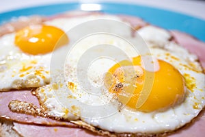 Closeup of a meat sandwich with fried egg. Yellow egg yolk. Uitsmijter