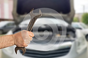 Closeup of mechanic holding wrench