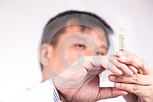 Closeup of medical doctor hand holding syringe for injection