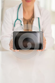 Closeup on medical doctor woman showing tablet pc