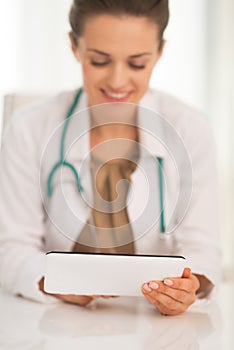 Closeup on medical doctor woman using tablet pc