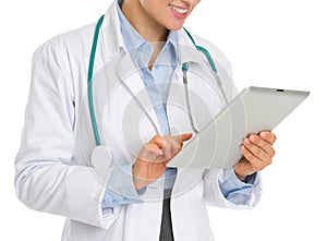 Closeup on medical doctor woman using tablet pc