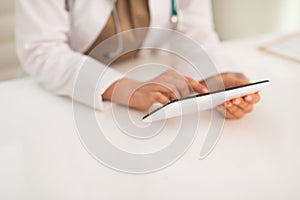 Closeup on medical doctor woman using tablet pc