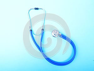 Closeup of a medical stethoscope on blue background