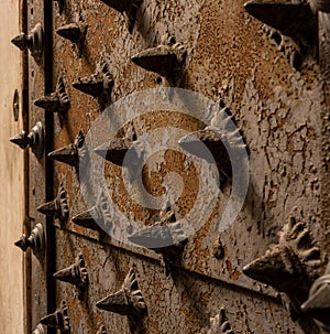 Closeup of a medieaval door with metal spines in genua, italy photo