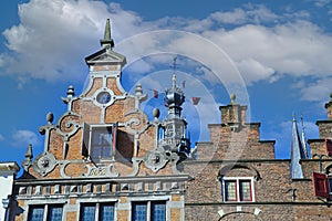 Closeup of medieval gabled house facades with church tower against blue summer sky - Nijmegen, Netherlands