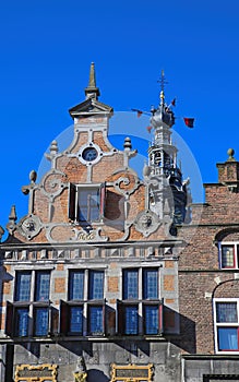 Closeup of medieval gabled house facades with church tower against blue summer sky - Nijmegen, Netherlands