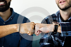 Closeup of men fist bumping photo