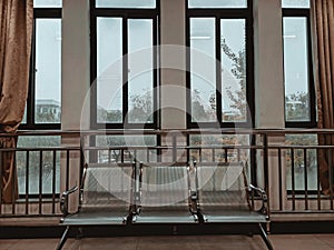 closeup of mental bench against windows of building