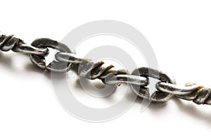 Closeup of a metal chain links with intertwine interweave twisted patterned metal works