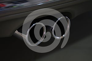 Closeup of metal exhaust pipe of sports car