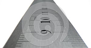 Closeup of metal ruler on a white background