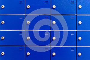 Closeup of metal safe deposit boxes. Outdoor parcel lockers for private delivery. Blue mailboxes.