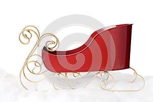 Closeup metal santa sleigh with gold runners on snow