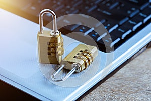 Metal security lock with password on computer keyboard