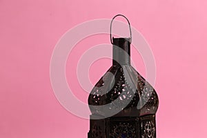 Closeup of a metallic lantern isolated on a pink background