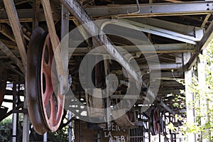 Closeup of metallic rusted turning wheel from coal mining cableway industrial equipment