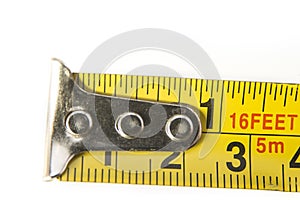 Closeup of meter tape in centimeters and inches on the white background.