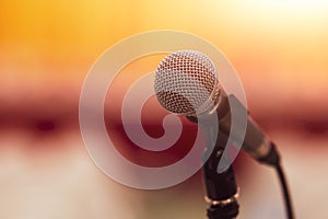 Closeup of microphone on abstract blurred background speech in seminar convention hall room and light as guest and conference