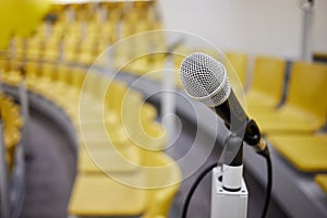 Closeup microphone on holder in conference hall, photo