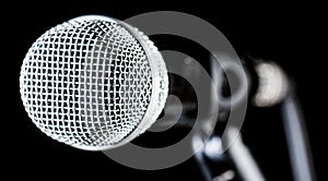 Closeup microphone, macro mic, karaoke, concert, voice music. Closeup microphone. Vocal audio mic on a bleck background