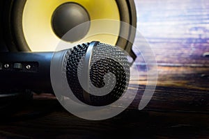 Closeup with microphone and speaker on vintage wooden table