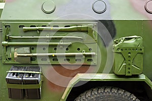 Closeup military armored vehicle with attached tool.