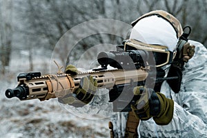 Closeup military man in white camouflage uniform with machinegun. Soldier aims of the machinegun