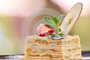 Closeup mille-feuille napoleon with apple and straberry slices.