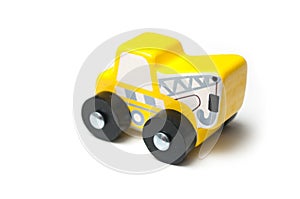 Miniature toy, wooden yellow tow truck on white background