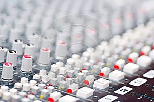 Closeup mixing faders and knobs as seen from above side angle, artistic studio equipment concept
