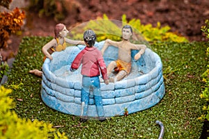 Closeup of model figures in a hot tub