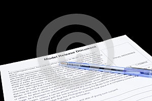 Closeup of model release document and a pen