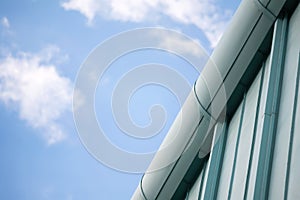 Closeup of a modern business building detail aganst blue sky wit