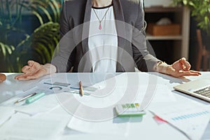 Closeup on modern business woman at work meditating